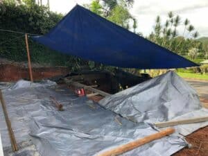 Blue Tarp Covers A Parked Car — Tropical Prestige Pools in Kuranda, QLD